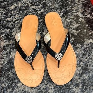 New. Coach black patent sandals.